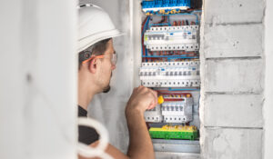 Electrician performing professional electrical installation work, ensuring safety and compliance with standards