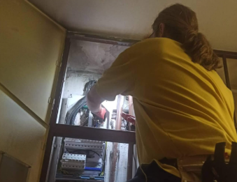 Electrician performing professional electrical installation work, ensuring safety and compliance with standards